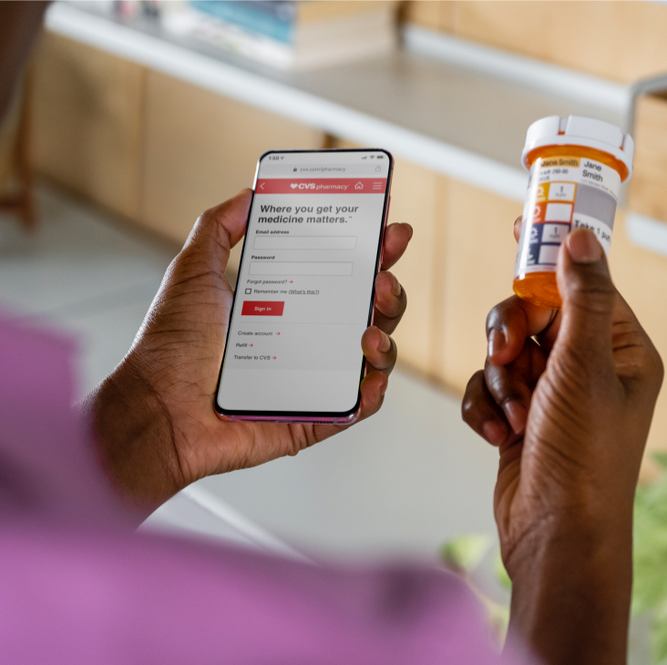 CVS customer using her mobile device to sign in and search for prescription savings.